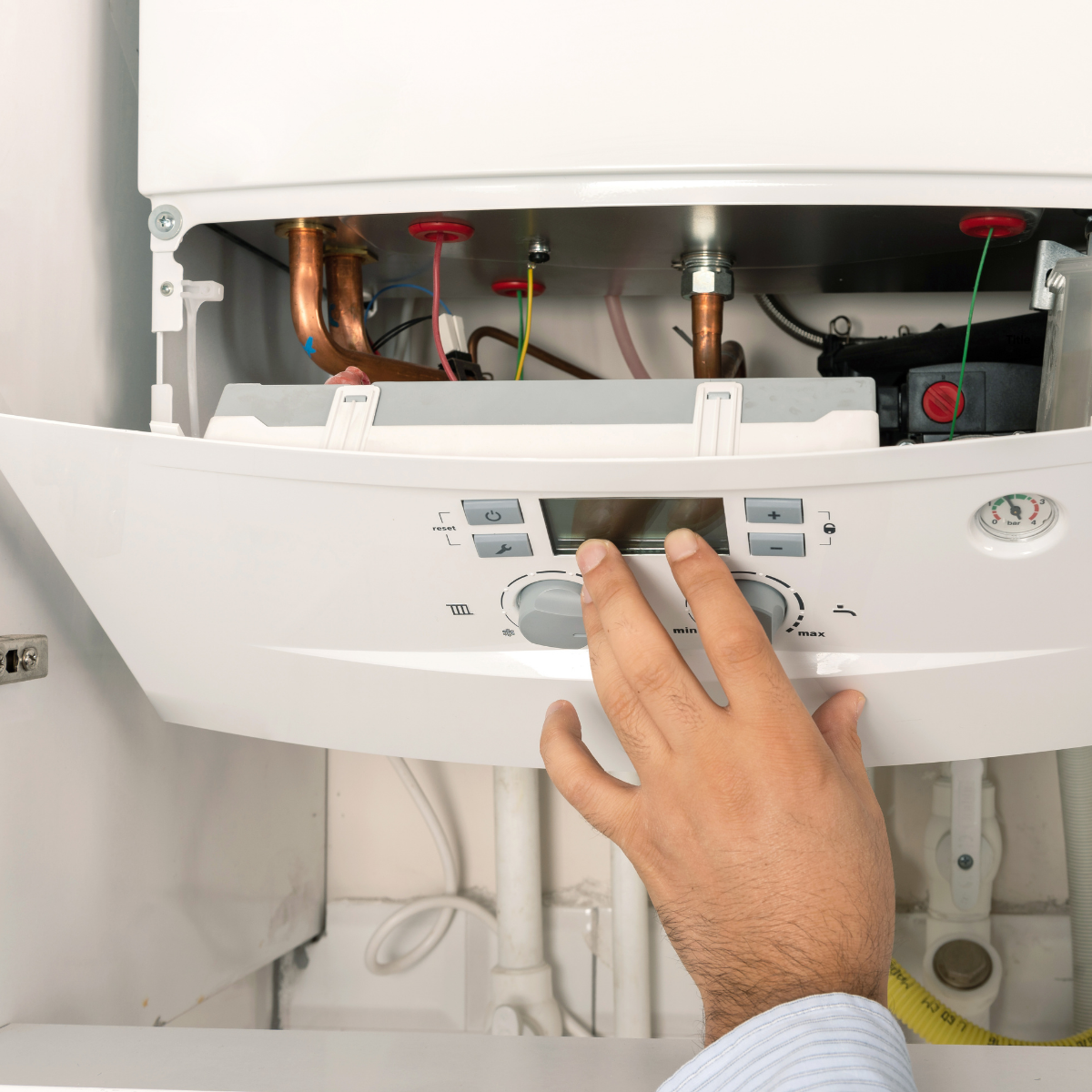 Ash adjusting the settings on an open boiler during a service